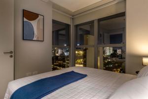 เตียงในห้องที่ ÚNICO - Stay & Residences by AVA