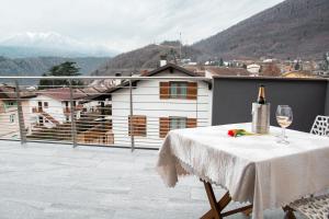 a table with a bottle of wine and a glass at Ivana-suite CIPAT 022104-AT-013433 in Levico Terme