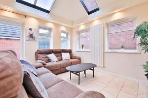 a living room with a couch and a table at StayRight Spacious 5-Bed House with Parking - 15 mins from City Centre! in Cardiff