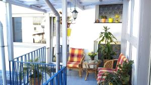 a porch with two chairs and a table at Ferienhaus Loreleytal in Boppard