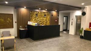 a lobby with a reception desk and a counter at Rudolfo Suites in Roxas City