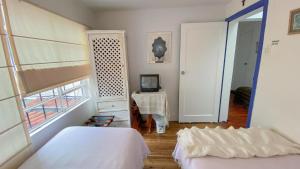 Postelja oz. postelje v sobi nastanitve Sakti Hostal B&B