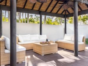 a patio with two couches and a table at Modern 4BR Holiday Home W Pool BBQ Oxenford in Gold Coast