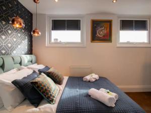 a bedroom with a bed with two towels on it at Pass the Keys Bespoke Coastal Retreat Whitley Bay in Whitley Bay