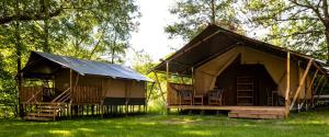 two large huts in a field with trees at Landgasthof Probstei Zella in Frankenroda