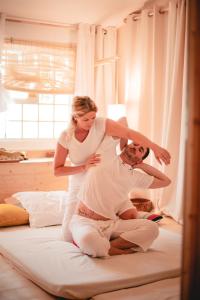 a woman standing on top of a man on a bed at Toison D'or in Saint-Tropez