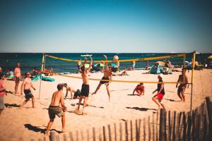 a group of people playing volleyball on the beach at Toison D'or in Saint-Tropez