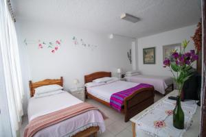 Postelja oz. postelje v sobi nastanitve Sakti Hostal B&B