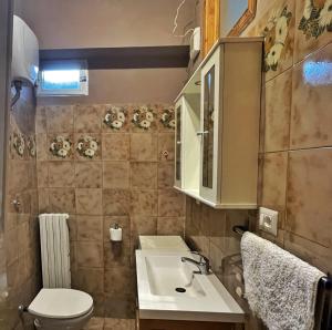 a small bathroom with a sink and a toilet at Cleo Magnolia in Falconara Marittima