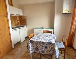 une petite cuisine avec une table et une table et des chaises dans l'établissement Cleo Magnolia, à Falconara Marittima 1 autre photo