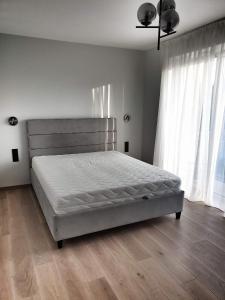 sypialnia z łóżkiem w pokoju z drewnianą podłogą w obiekcie Luxury Home in Vilnius w Wilnie