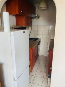 a kitchen with a white refrigerator and a stove at apartment in Krakow