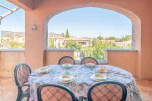 een eetkamer met een tafel en stoelen en een raam bij Appartamento I Lecci in San Teodoro