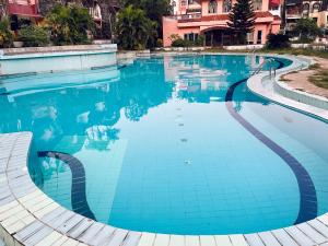 a large swimming pool with blue water at Luxurious 2 BHK Villa AniRah Homes 2 minutes to beach in Colva