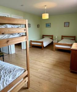 two bunk beds in a room with wooden floors at VILLA LES MOUETTES - Maison 8 couchages in Quiberville