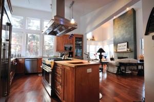 a kitchen with wooden floors and a stove top oven at Lodging at Goose Cove Retreat - Trinity, Newfoundland in Trinity