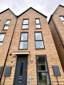 a brick building with a black door and windows at Birmingham Bliss Central 5-Bed Escape in Birmingham