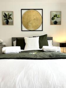 a bedroom with a large bed with two pillows at Birmingham Bliss Central 5-Bed Escape in Birmingham