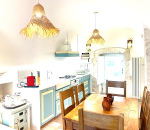 a kitchen with blue cabinets and a wooden table at Donna Vincenza in Selva di Fasano