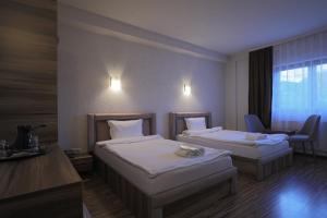 Postel nebo postele na pokoji v ubytování Hotel Denis