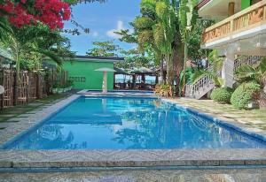 a swimming pool in the backyard of a house at Palm Garden Resort in Carles