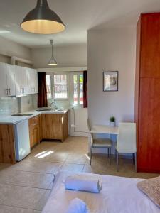 a kitchen and dining room with a table and chairs at A&D Apartments in Porto Rafti