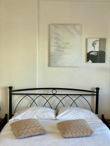 a bedroom with a bed with two pillows on it at A&D Apartments in Porto Rafti