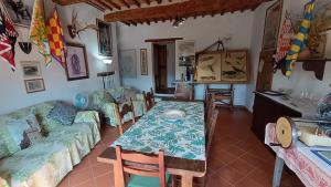 a living room with a table and a couch at Agriturismo Podere Tegline in Radda in Chianti