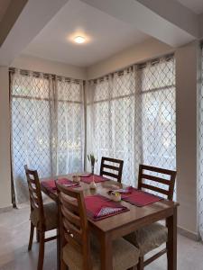 a dining room table with four chairs and a table and chairsktop at GG in Imphal +36 photos