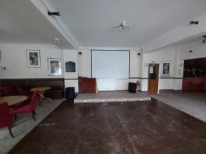 a large room with a white projection screen in it at Channel View Hotel in Sandown