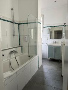 a bathroom with a shower and a tub and a sink at dreams Düsseldorf in Düsseldorf