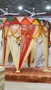 a stage with colorful umbrellas on a table at Shree R.C.VATIKA in Motīhāri