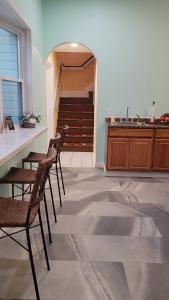 2 Stühle und ein Tisch in einem Zimmer mit Treppen in der Unterkunft Josephine's Bed & Breakfast in Titusville