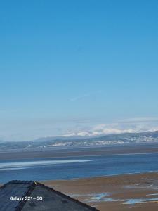 a view of the ocean with mountains in the distance at The Gateway at Hest Bank in Lancaster