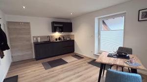 a kitchen with a table and a dining room at Heimatliebe Erfweiler Wohnung VIER in Erfweiler