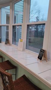 a counter with two signs on it in front of a window at Josephine's Bed & Breakfast in Titusville