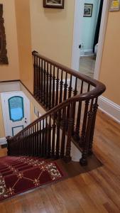 a wooden staircase with a wooden floor and a stair case at Josephine's Bed & Breakfast in Titusville