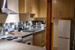 a kitchen with a sink and a stove top oven at Radcliffe Studio in Nottingham