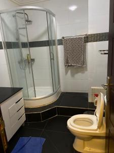 a bathroom with a shower and a toilet at Harmonie ville in Dakar