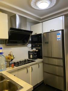 a kitchen with a stove and a refrigerator at Harmonie ville in Dakar