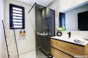 a bathroom with a sink and a shower at La Maison Du Bonheur - Villa moderne avec SPA in Saint-Joseph +23 photos
