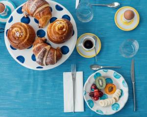 two plates of pastries and coffee on a blue table at Relais Corte Degli Aragonesi in Ischia