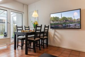 a dining room with a black table and chairs at Haus Harle 50204 Ferienwohnung Harle 3 in Harlesiel