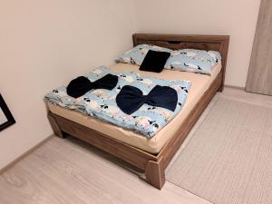 a bed with two bow ties on it at Flat near the Vyšehrad Castle in Prague
