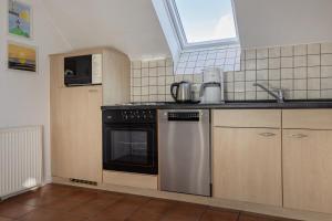 a kitchen with a sink and a dishwasher at Haus Harle 50205 Ferienwohnung Harle 4 in Harlesiel