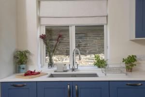 a kitchen with a sink and a window at The Nineteenth in Wadebridge