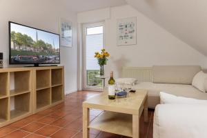 a living room with a couch and a tv at Haus Harle 50202 Ferienwohnung Harle 2 in Harlesiel