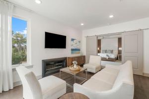 a living room with a couch and a fireplace at the Pointe Unit 326 in Rosemary Beach