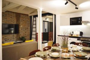 a dining room with a table and a kitchen at Magnificient Parisian Flat - Parisian heart in Paris +26 photos