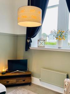 a living room with a desk and a window at The Old Schoolhouse, Kinross in Kinross